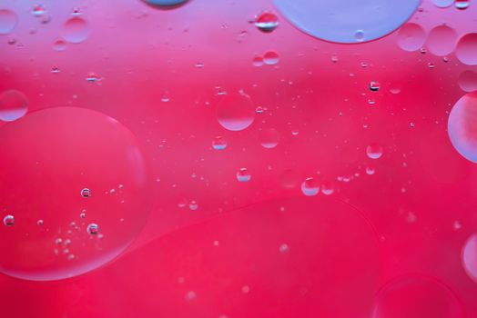 Oil drops in water. Defocused abstract psychedelic pattern image red colored. Abstract background with colorful gradient colors. DOF.