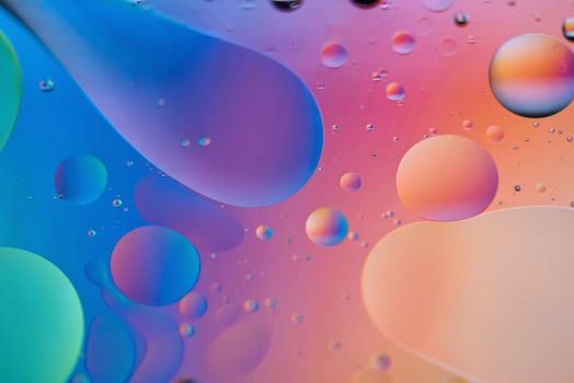 Oil drops in water. Defocused abstract psychedelic pattern image orange and blue colored. Abstract background with colorful gradient colors. DOF.