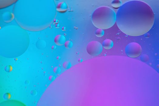 Oil drops in water. Abstract defocused psychedelic pattern image blue and purple colored. Abstract background with colorful gradient colors. DOF.
