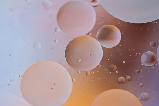 Oil drops in water. Defocused abstract psychedelic pattern image orange and gray colored. Abstract background with colorful gradient colors. DOF.