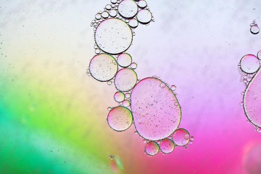 Colorful abstract background with oil drops on water. Rainbow color
