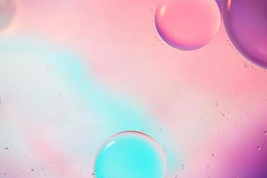 Oil drops in water. Defocused abstract psychedelic pattern image pastel colored. Abstract background with colorful gradient colors.