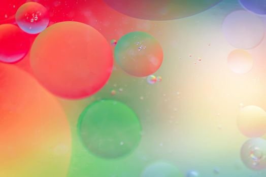 Oil drops in water. Abstract defocused psychedelic pattern image red and green colored. Abstract background with colorful gradient colors. DOF