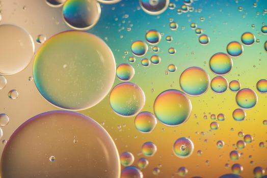 Oil drops in water. Abstract psychedelic pattern image rainbow colored. Abstract background with colorful gradient colors. DOF.