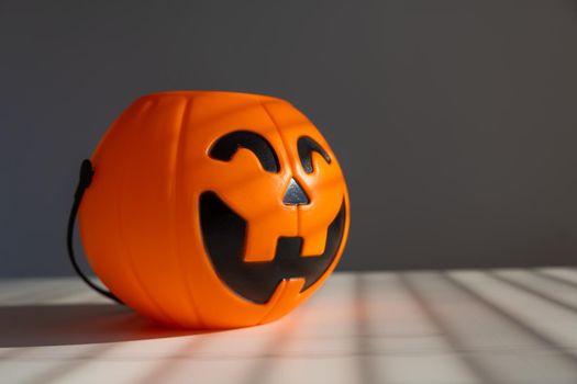 A basket for sweets in the shape of a pumpkin jack on a lantern on a white background