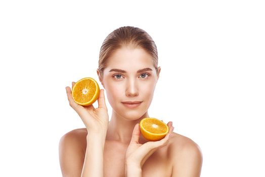 Beautiful womans face with orange close up studio photo on white background. Light hair, grey eyes