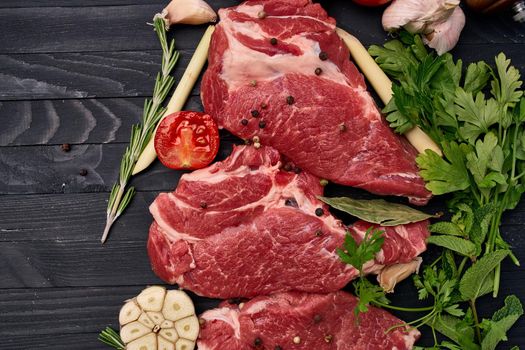 meat on wooden board vegetables and ingredients for cooking wooden background. High quality photo