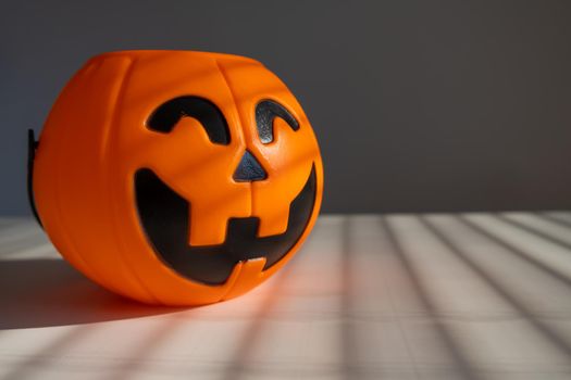 A basket for sweets in the shape of a pumpkin jack on a lantern on a white background