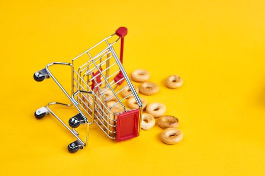 carts with groceries shopping supermarket store yellow background. High quality photo