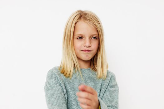 Little cute girl gestures with his hands kids lifestyle concept. High quality photo