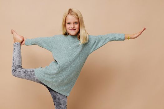 Little cute girl with blond hair posing studio. High quality photo