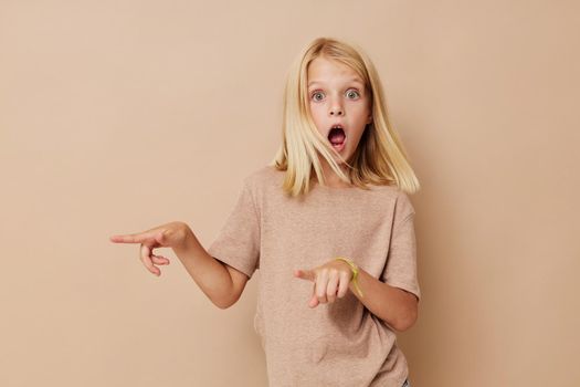emotional girl with blond hair on a beige background. High quality photo