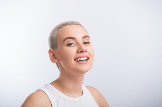 Young caucasian woman with short hair on a white background