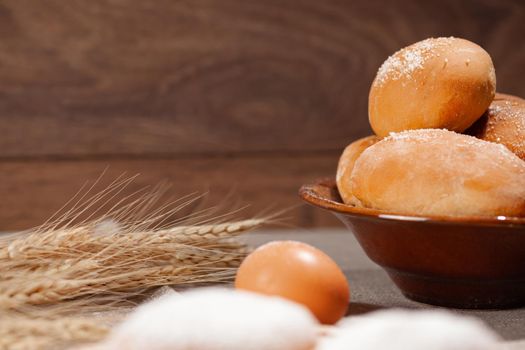 homemade pastries on a dark wooden background, pies in a plate, place under the text, copy space