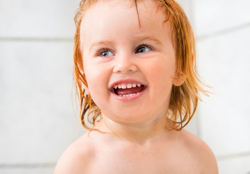 Portrait of beautiful smiling baby in bathroom