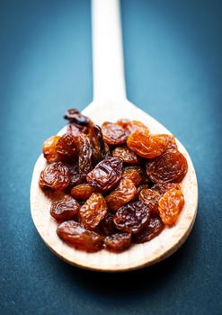 Raisins in a wooden spoon