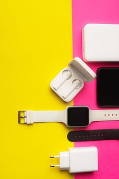 Layout of modern gadgets on a pink and yellow background . Online communication. Internet connection. Mobile communication. 5g. Black and white technology. Modern technologies. Copy space