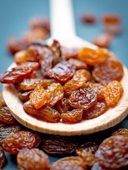 Raisins in a wooden spoon