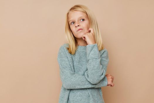 Positive little girl with blond hair kids lifestyle concept. High quality photo