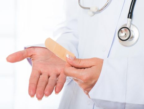 Female doctor's hands with patch