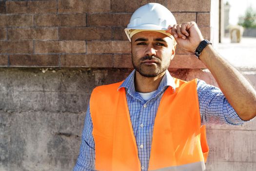 Portrait of young construction engineer wearing hardhat, close up