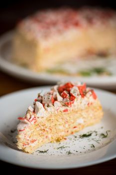 piece of snack cake stuffed with crab sticks in a plate on a wooden table