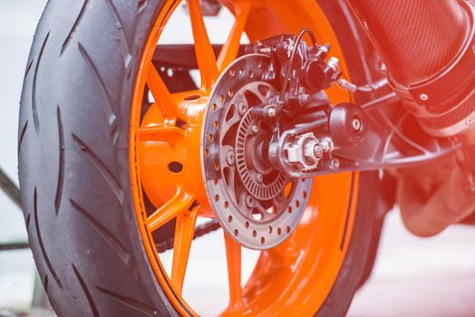 Rear orange wheel of sport bike