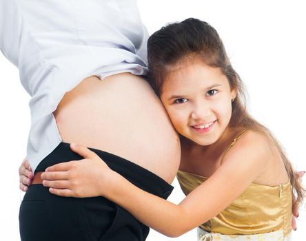 cute little girl hugging belly pregnant mom