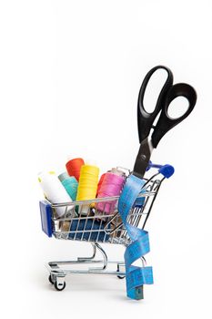 Trolley with thread on a white background . Thread selection. Shopping for needlework. White background. Copy space