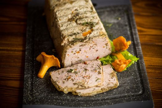 homemade sausage from minced meat with mushrooms and vegetables inside, on a wooden table
