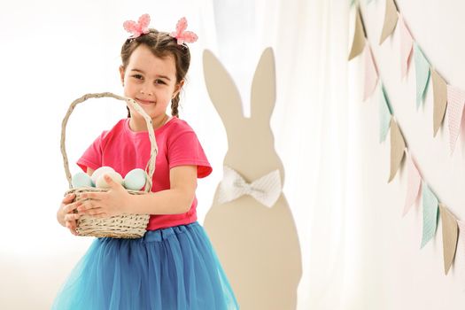 bunny ears and basket of Easter eggs