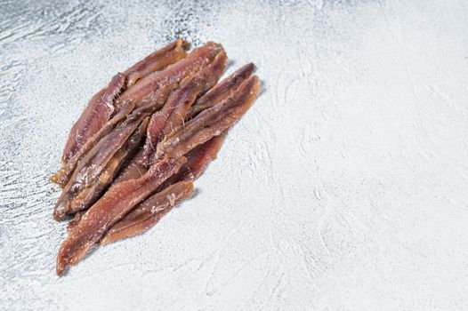 Canned Anchovies fish fillet in Olive Oil. White background. Top view. Copy space.