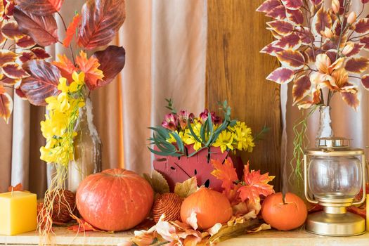 Autumn composition. Pumpkins, candles and dried flowers. Autumn, fall halloween concept
