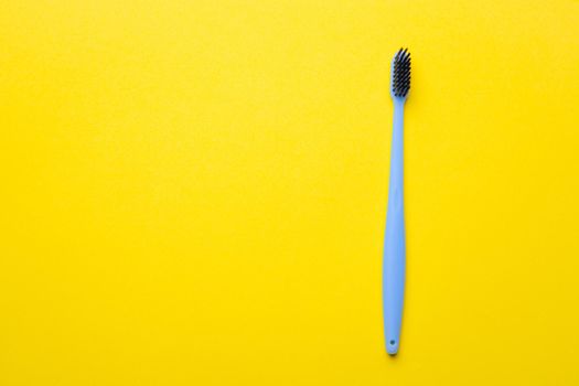 A toothbrush on a yellow background . Silicone toothbrush. Copy space. Yellow background. Dental care. Dentistry. Choosing a toothbrush