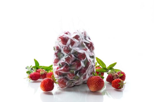 frozen fresh strawberries in a vacuum bag isolated on white background