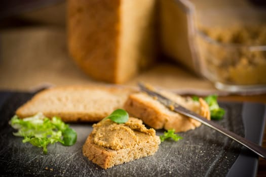 homemade meat pate with homemade bread on a wooden table