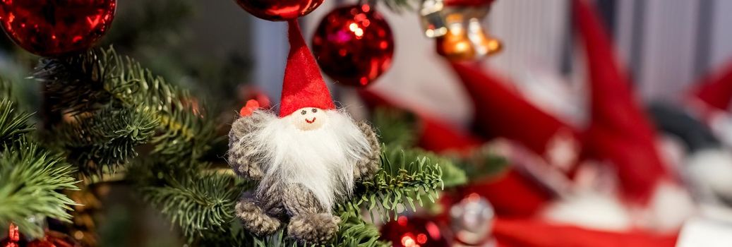 Christmas tree with red purple and white toys and flowers in the interior. Traditional christmas tree