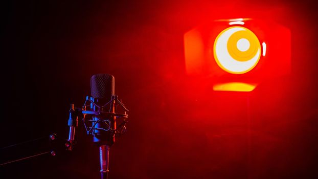 Professional microphone in red smoke on a black background