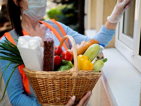 A female volunteer leaves food at home during the coronavirus pandemic.