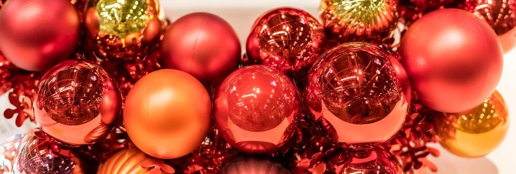 Christmas wreath with glass pink and violet balls isolated on white background