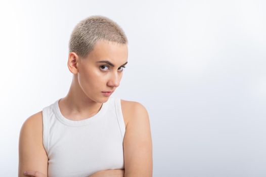 Displeased young caucasian woman with short haircut on white background