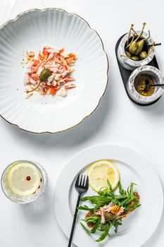 Salad with Crab meat on a kitchen table. White background. Top view.