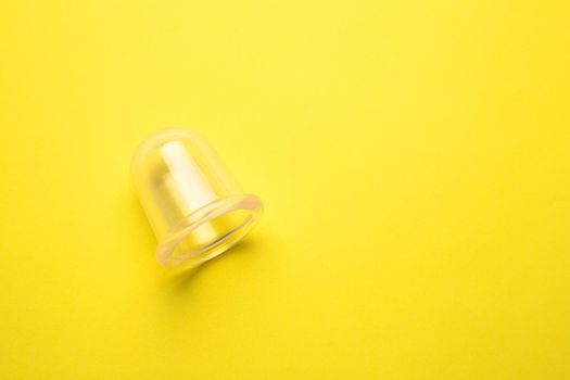 vacuum body massager on a yellow background copy device. an article about massage. how to remove cellulite