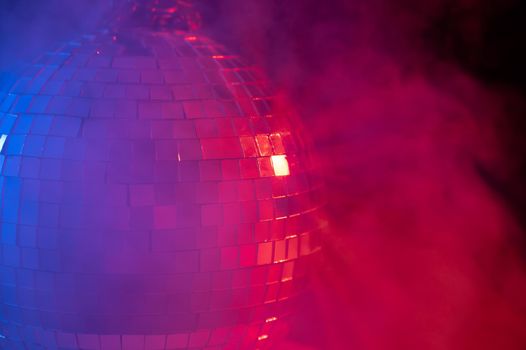 The disco ball is spinning in pink-blue smoke. Night life