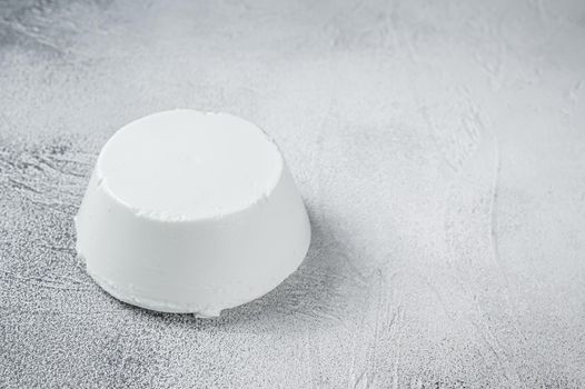 Ricotta cream Cheese on kitchen table. White background. Top view. Copy space.