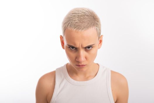 Displeased young caucasian woman with short haircut on white background