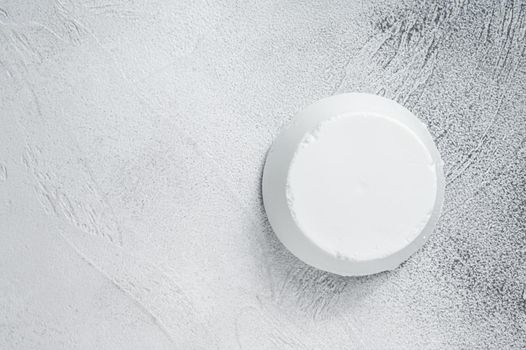 Ricotta cream Cheese on kitchen table. White background. Top view. Copy space.