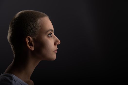 Portrait of pensive young woman with short hair on white background. Copy space.