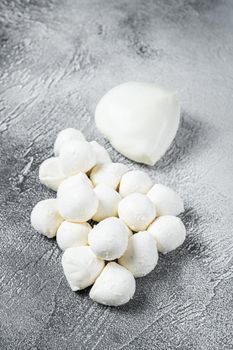 Mozzarella cheese mini balls on kitchen table. White background. Top view.