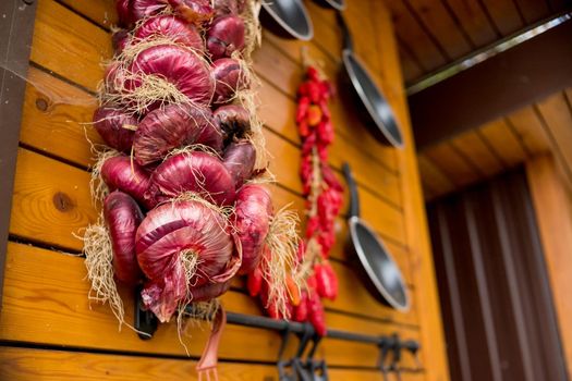 Colourful display of Mediterranean vegetables hanging to dry in a market stall